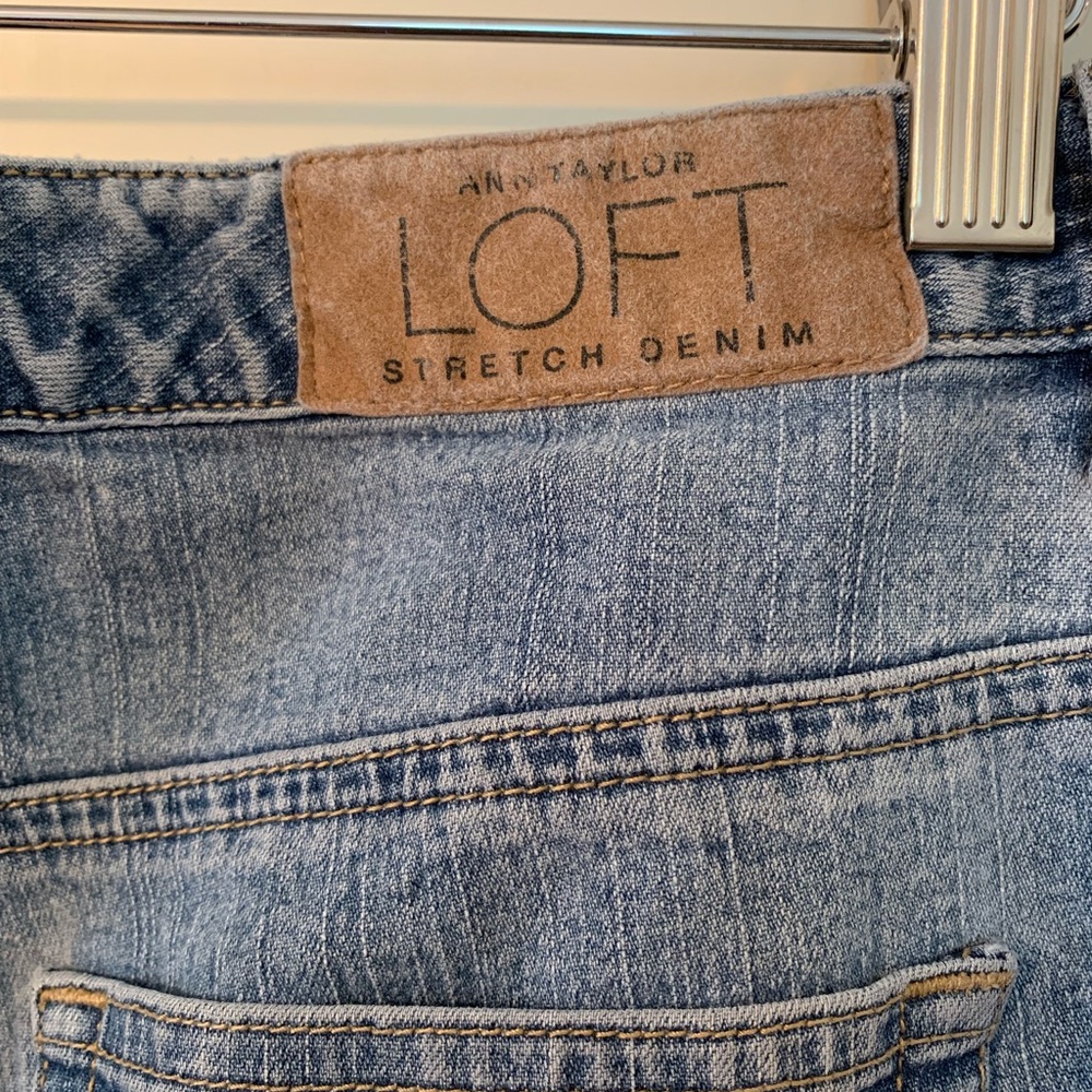 Medium-wash stretch denim blue jeans. Size 10 Petite.